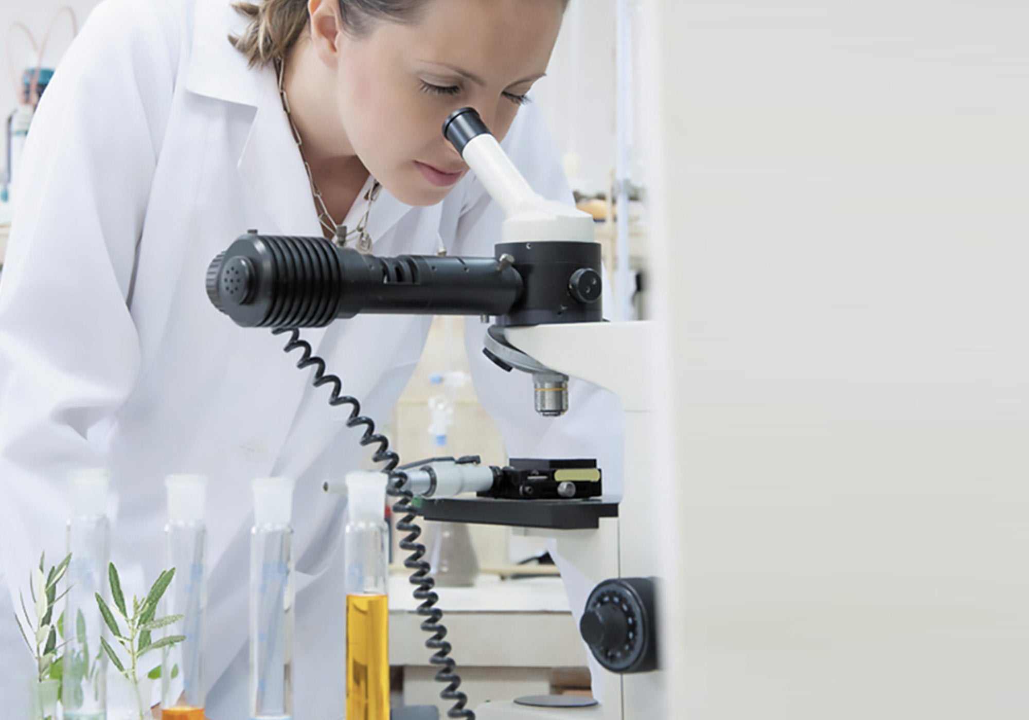 Doctor who is observing under a microscope